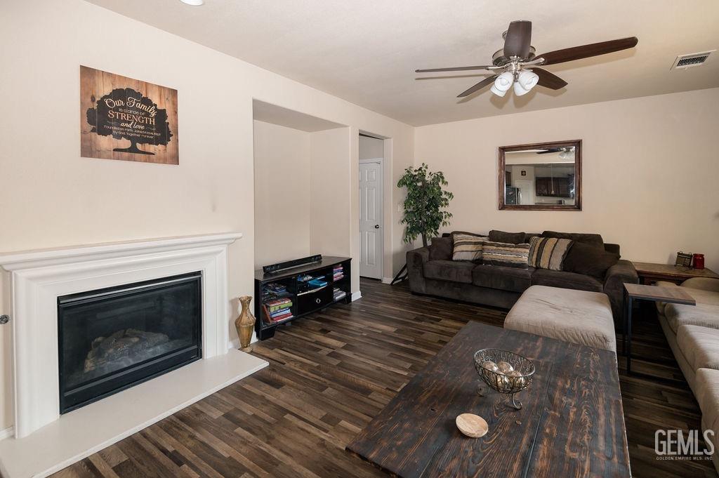 Undisclosed Address Bakersfield, CA 93314 - Photo 23 of 54 a living room with furniture and a fireplace