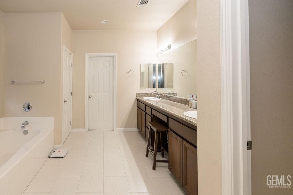 Undisclosed Address Bakersfield, CA 93314 - Photo 29 of 54 a view of a kitchen cabinets and a stove