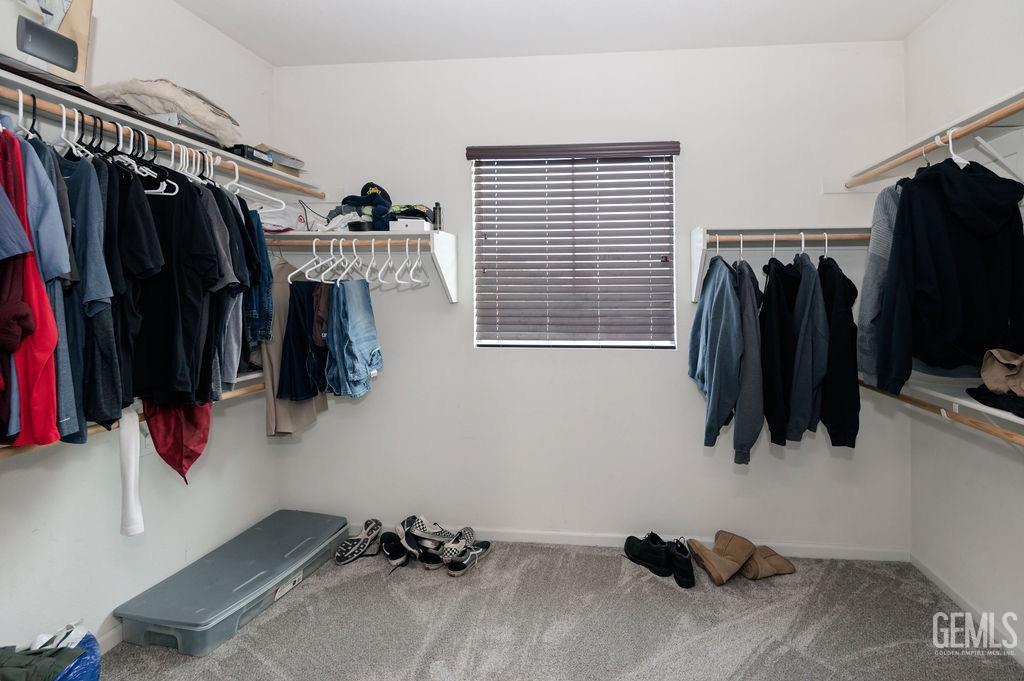 Undisclosed Address Bakersfield, CA 93314 - Photo 30 of 54 a walk in closet with clothes and shoes
