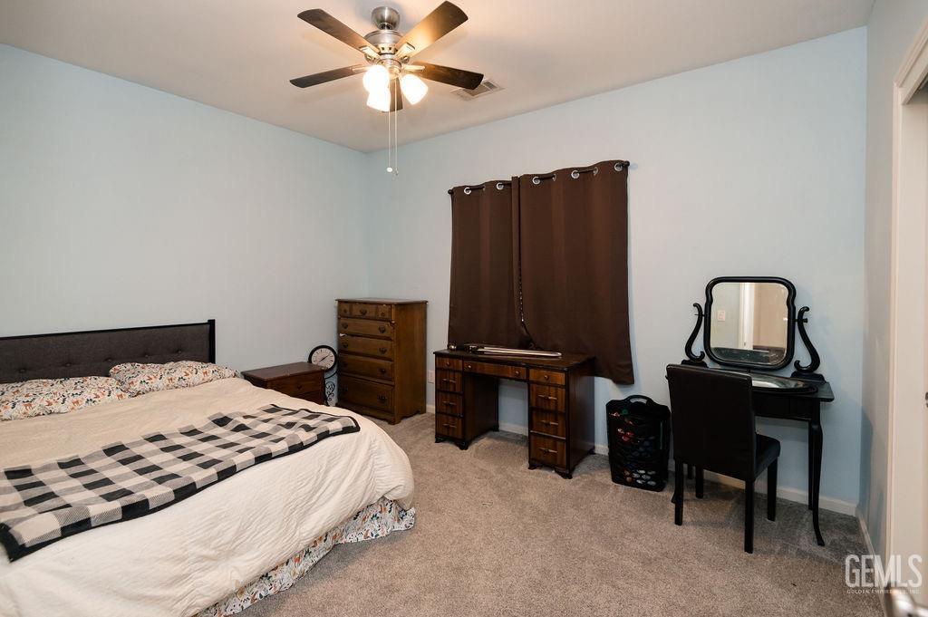 Undisclosed Address Bakersfield, CA 93314 - Photo 32 of 54 a bedroom with a bed and a chandelier