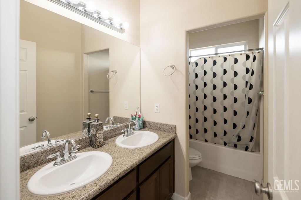 Undisclosed Address Bakersfield, CA 93314 - Photo 34 of 54 a bathroom with a granite countertop sink and a mirror