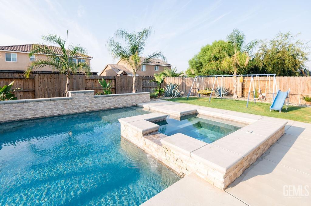 Undisclosed Address Bakersfield, CA 93314 - Photo 39 of 54 a view of a backyard with swimming pool
