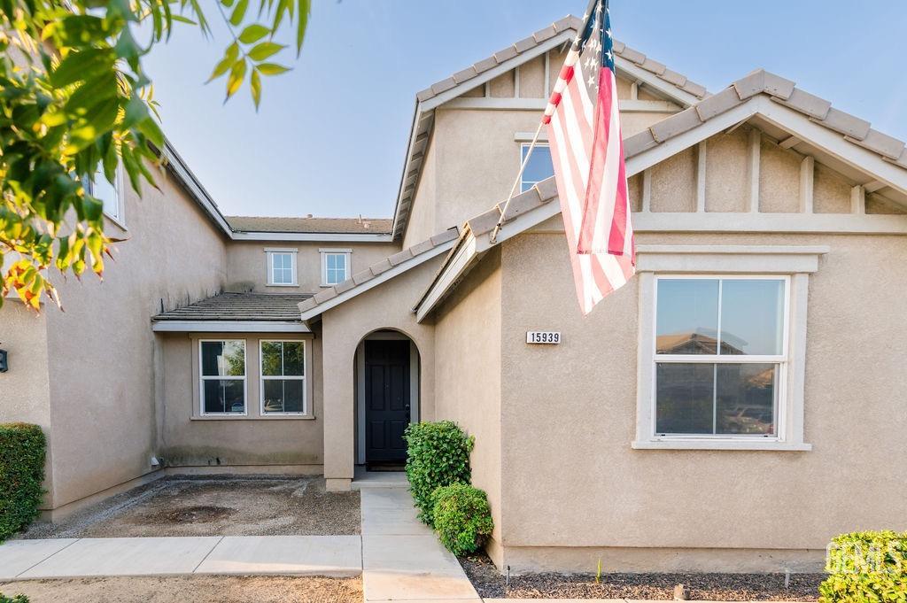 Undisclosed Address Bakersfield, CA 93314 - Photo 4 of 54 a front view of a house with a yard