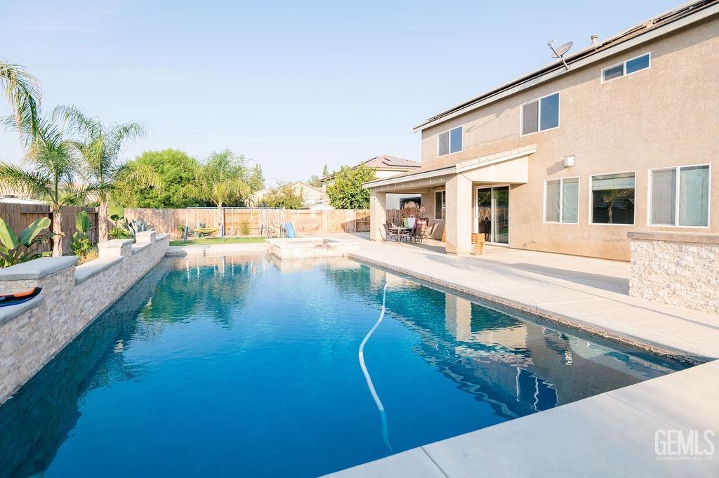 Undisclosed Address Bakersfield, CA 93314 - Photo 47 of 54 a swimming pool with outdoor seating and yard