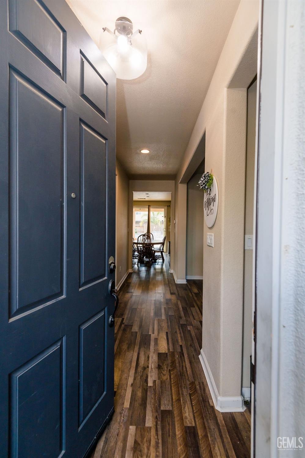 Undisclosed Address Bakersfield, CA 93314 - Photo 5 of 54 a view of a hallway and a livingroom with wooden floor