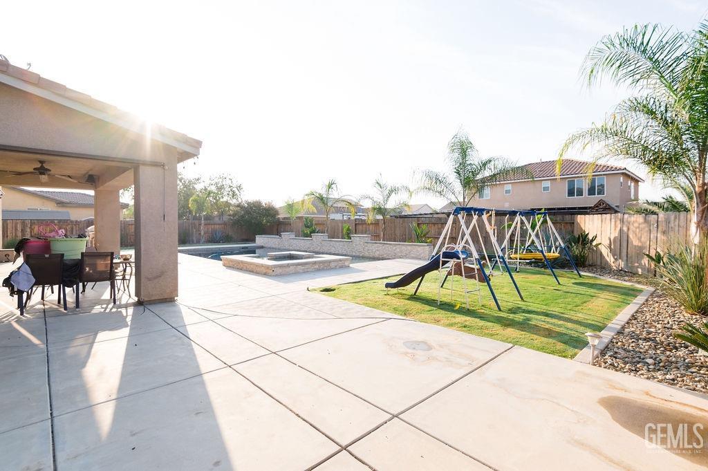 Undisclosed Address Bakersfield, CA 93314 - Photo 52 of 54 a view of playground with a slide and bench