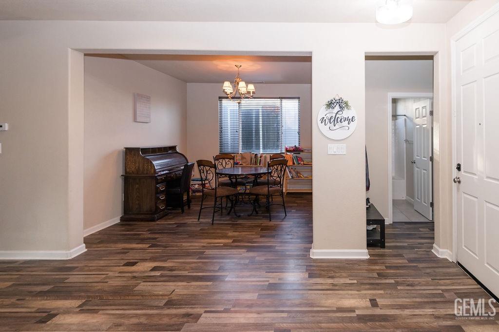 Undisclosed Address Bakersfield, CA 93314 - Photo 6 of 54 a living room with furniture and a wooden floor