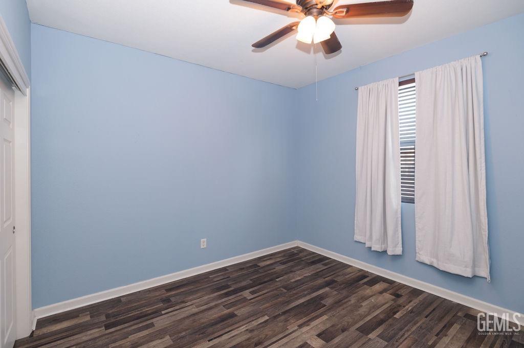 Undisclosed Address Bakersfield, CA 93314 - Photo 8 of 54 wooden floor in an empty room with a window