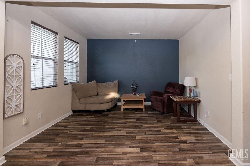 Undisclosed Address Bakersfield, CA 93314 - Photo 9 of 54 a living room with furniture and a wooden floor
