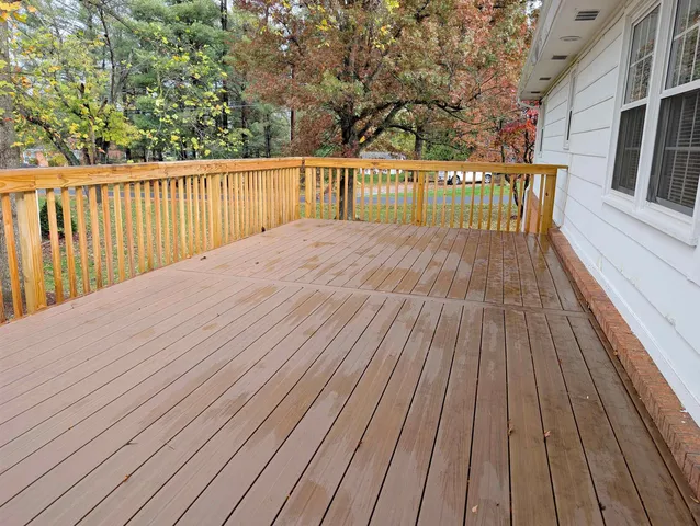 a view of backyard with a wooden deck