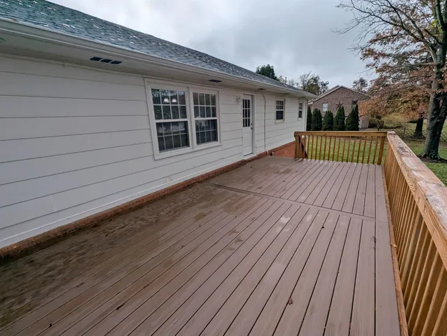 a view of deck with wooden floor and fence