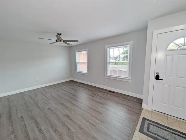 wooden floor in an empty room with a window