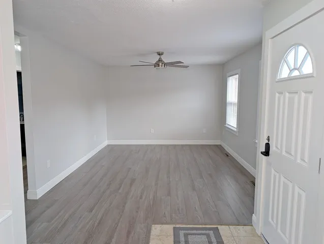 wooden floor in an empty room with a window
