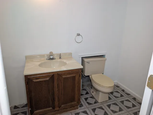 a bathroom with a sink toilet and a mirror