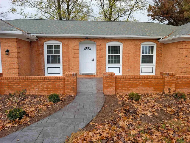 front view of a house with a large window