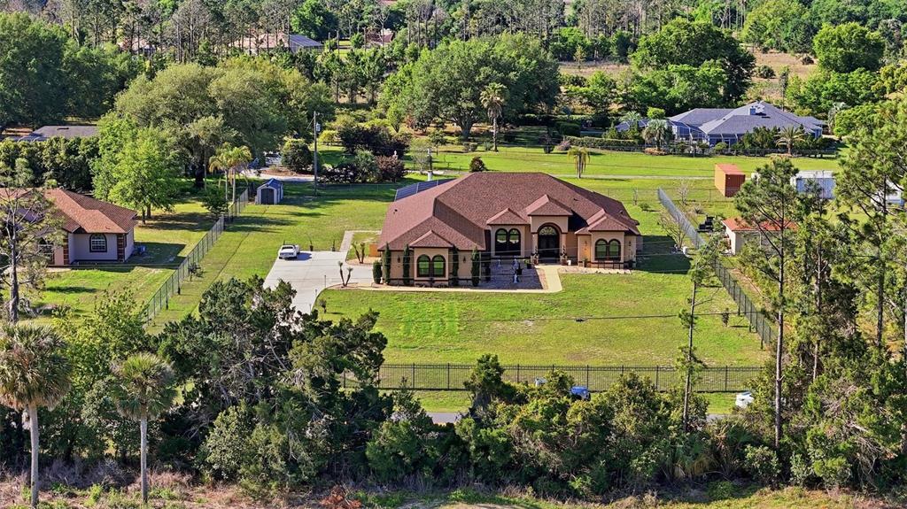 13429 Montevista Road Clermont, FL 34711 - Photo 83 of 89 an aerial view of a house with a garden and lake view