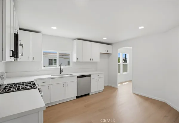 a kitchen with a sink stove and cabinets