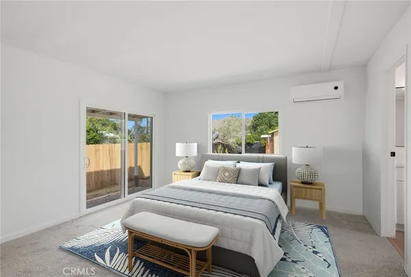 a bedroom with a bed and glass window