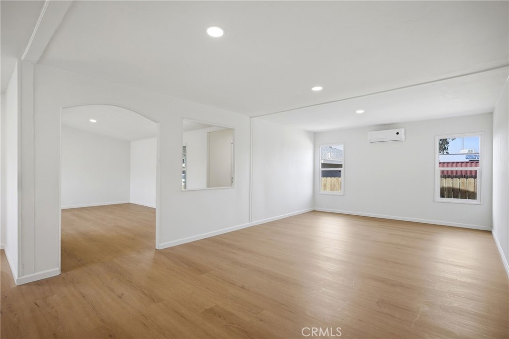 33098 Finch Street Winchester, CA 92596 - Photo 7 of 36 an empty room with wooden floor and windows