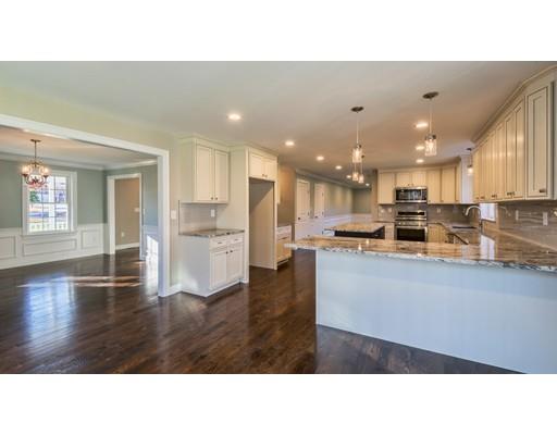 320 Boston Road Chelmsford, MA 01824 - Photo 6 of 30 a living room with stainless steel appliances kitchen island granite countertop a refrigerator a stove a sink dishwasher and white cabinets with wooden floor