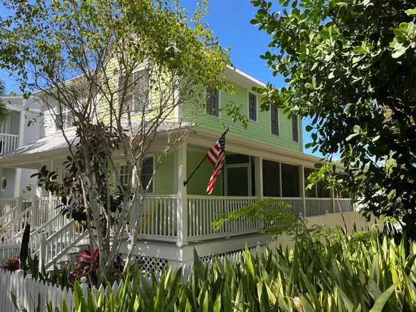 a view of a house with a small yard and plants