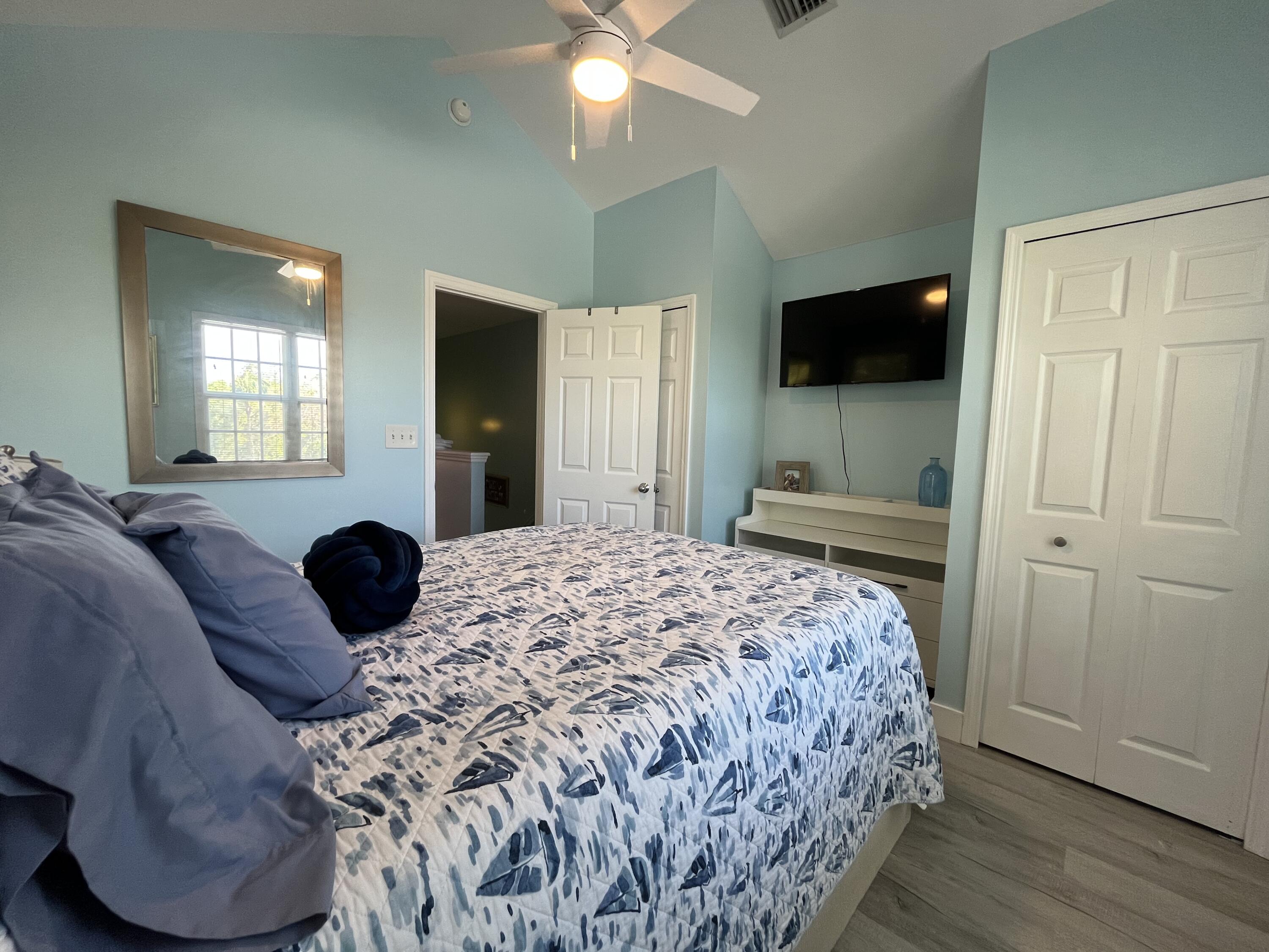 68 Merganser Lane Key West, FL 33040 - Photo 19 of 21 a bedroom with a bed and a flat tv screen on dresser