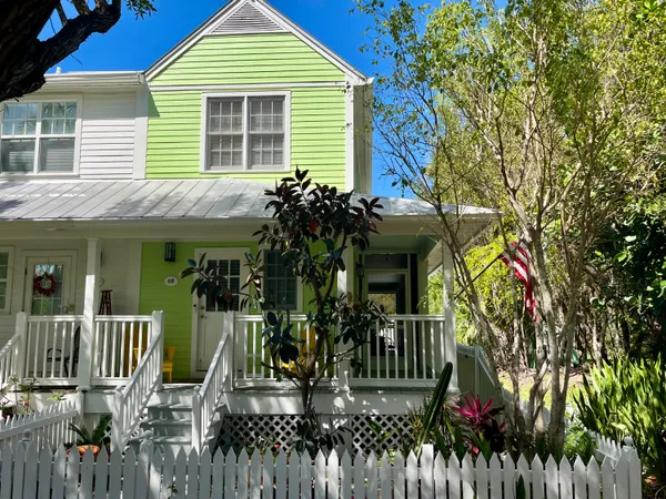a view of a house with a porch and furniture