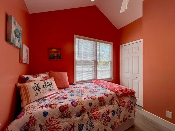 a bedroom with a large bed and a window