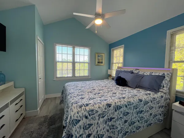 a bedroom with a large bed and a window