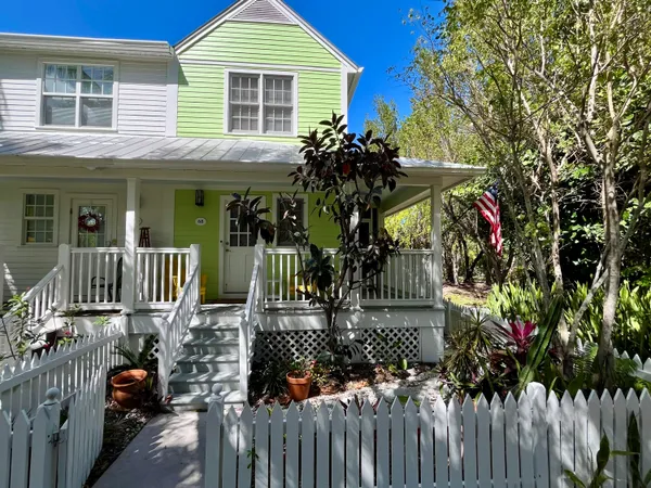 a view of a house with wooden fence