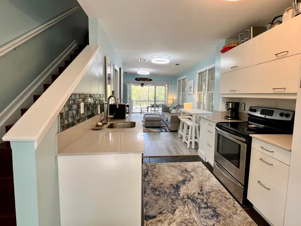 a kitchen with a sink a counter top space stainless steel appliances and a window