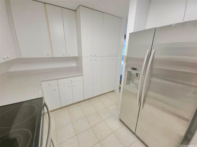 a view of a room with an empty space and window