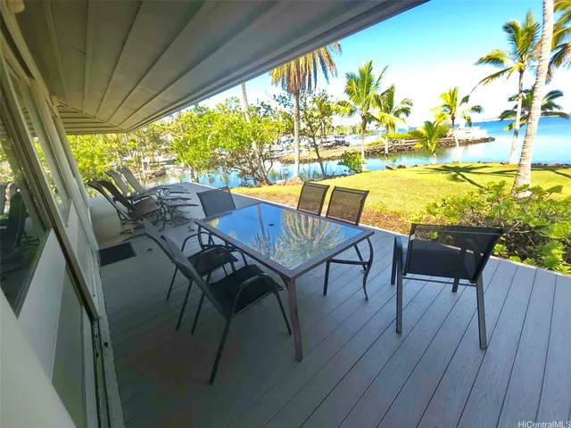 a view of a chairs and table on the balcony