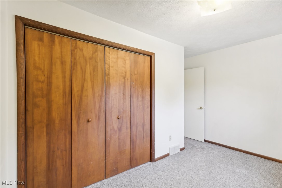 22120 Center Road Alliance, OH 44601 - Photo 35 of 41 Unfurnished bedroom with carpet and a closet