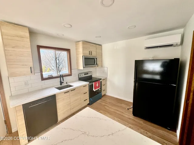 a view of a house with a wooden deck