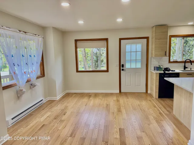 a large white kitchen with a sink and refrigerator