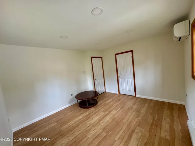 a view of room with window and wooden floor