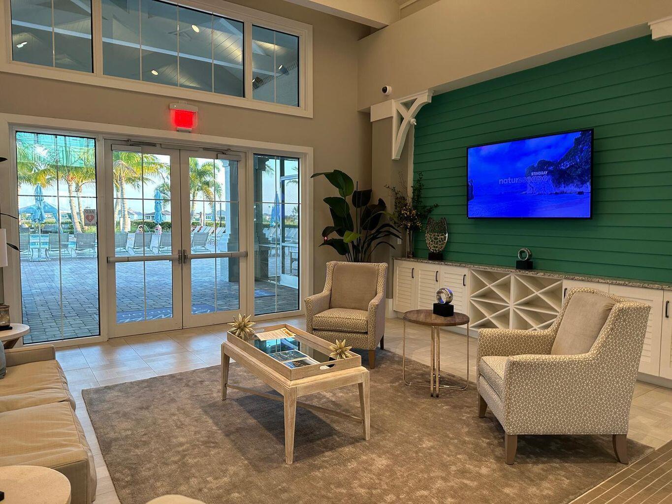 13897 Southwest Gingerline Drive Port St. Lucie, FL 34987 - Photo 22 of 74 a living room with furniture and a floor to ceiling window