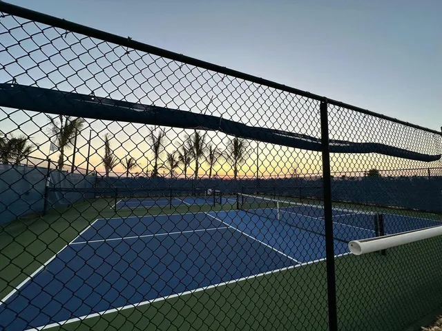 a living room with furniture a chandelier and a flat screen tv