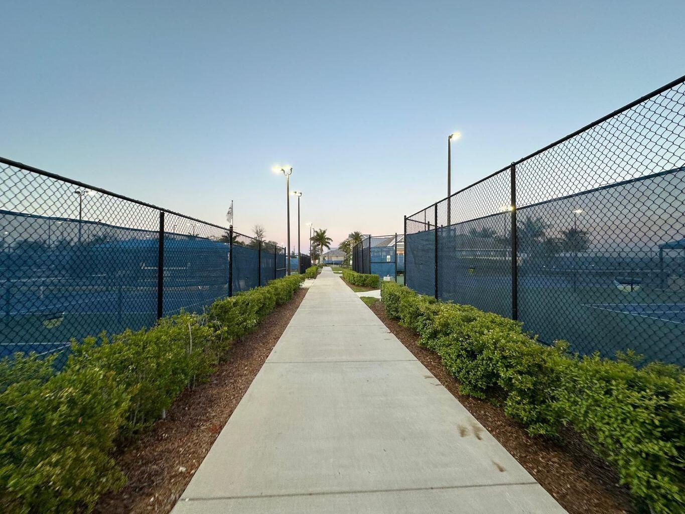 13897 Southwest Gingerline Drive Port St. Lucie, FL 34987 - Photo 27 of 74 a view of a pathway along a garden
