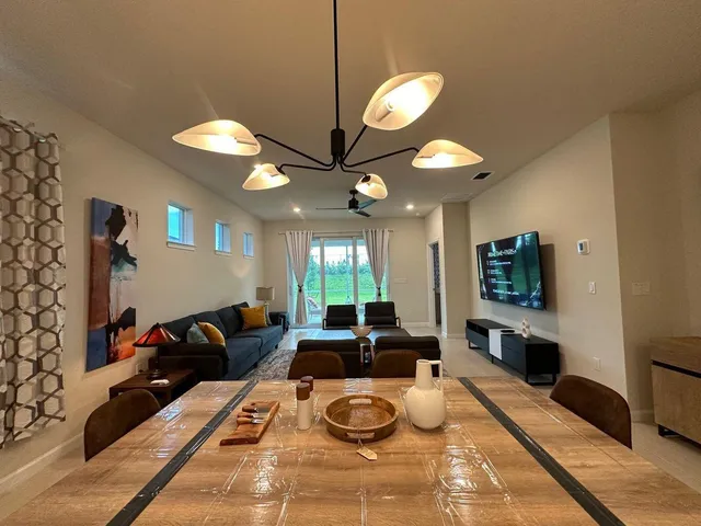 a living room with a piano and a table