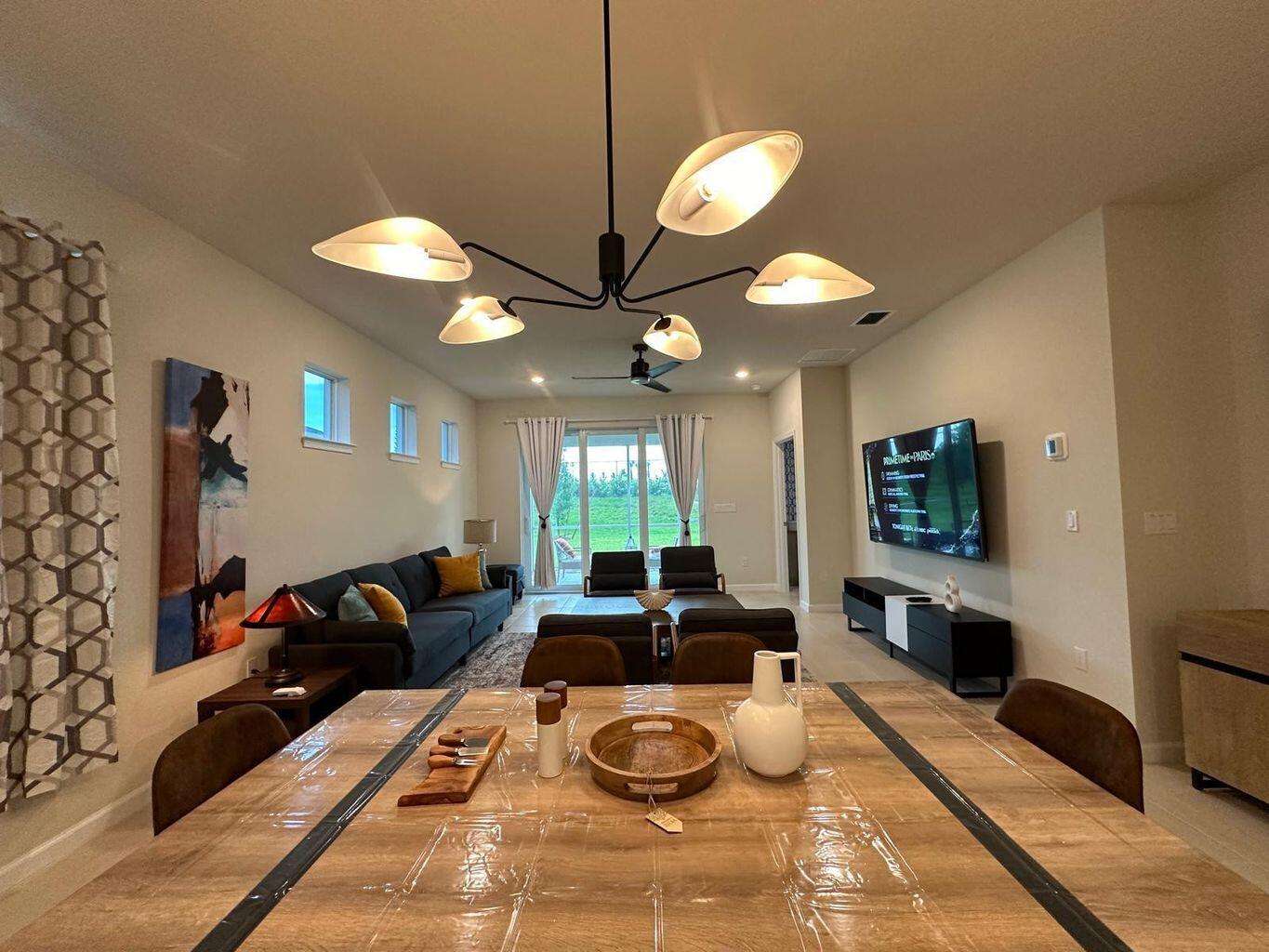 13897 Southwest Gingerline Drive Port St. Lucie, FL 34987 - Photo 36 of 74 a living room with furniture and a flat screen tv