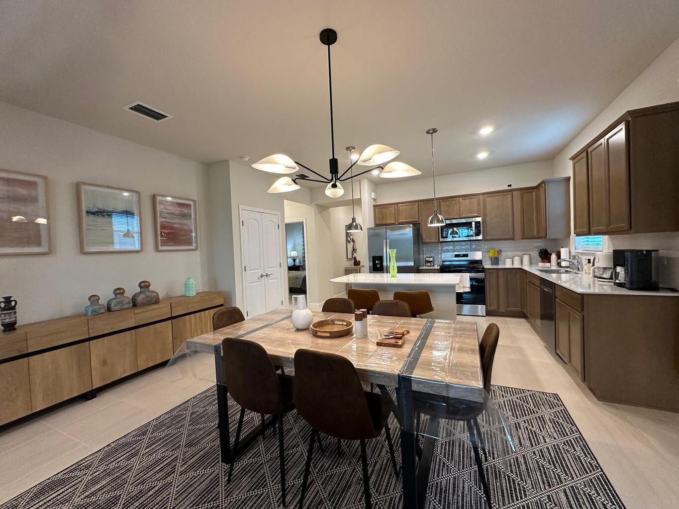 13897 Southwest Gingerline Drive Port St. Lucie, FL 34987 - Photo 4 of 74 a large kitchen with a table and chairs