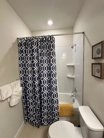 a bedroom with bed and a window