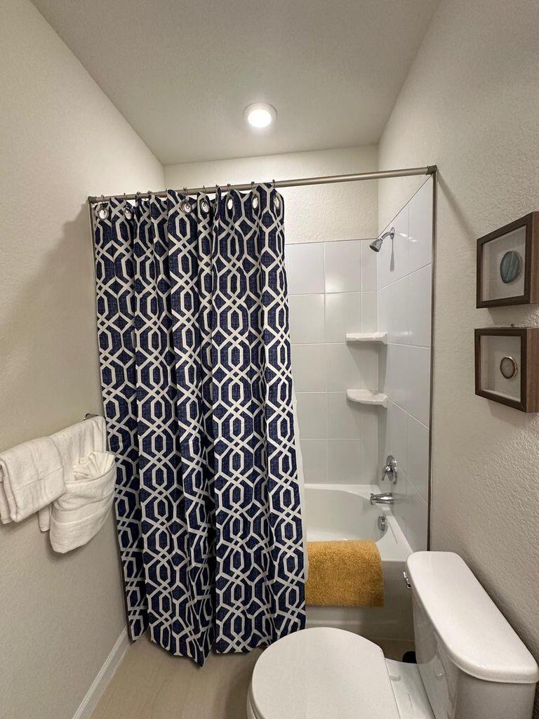 13897 Southwest Gingerline Drive Port St. Lucie, FL 34987 - Photo 41 of 74 a white toilet sitting next to a bathroom sink