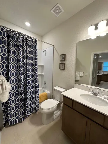 a bedroom with a bed next to a window with the dresser