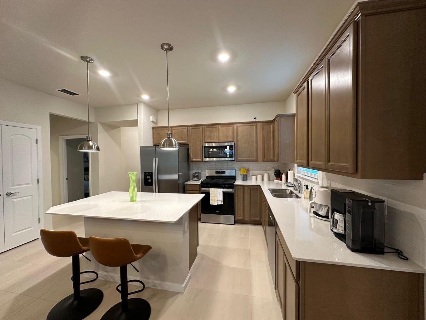 13897 Southwest Gingerline Drive Port St. Lucie, FL 34987 - Photo 44 of 74 a large kitchen with a table and chairs