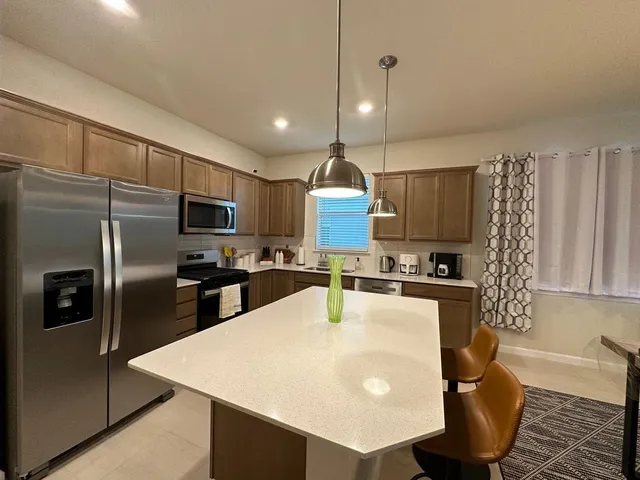 a bathroom with a double vanity sink mirror and shower