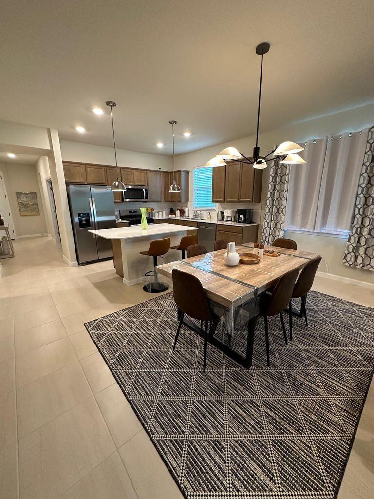 13897 Southwest Gingerline Drive Port St. Lucie, FL 34987 - Photo 5 of 74 a living room with a table and chairs