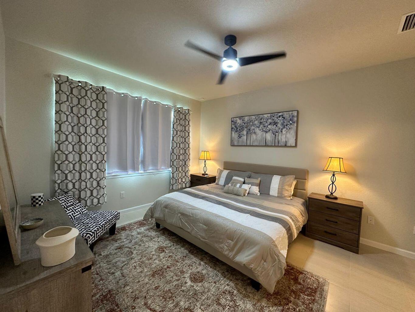 13897 Southwest Gingerline Drive Port St. Lucie, FL 34987 - Photo 54 of 74 a spacious bedroom with a bed and a chandelier